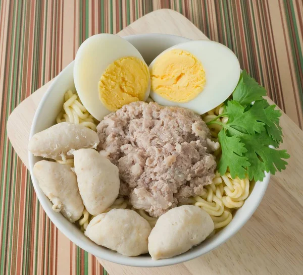 A Bowl of Instant Noodles with Meat Ball and Boiled Egg