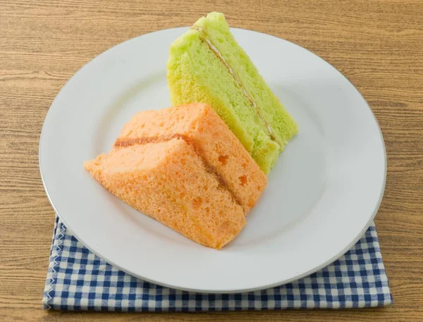 香兰和橙色雪纺蛋糕放到盘子里 — 图库照片