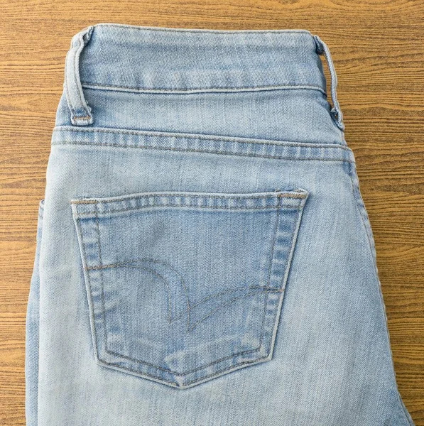 Blue Denim Jean on A Wooden Table — Stock Photo, Image