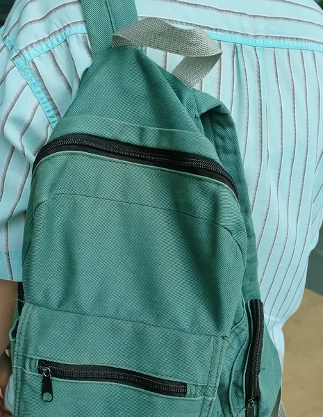 Young Man Holding A Classic Green Fabric Backpack — Stock Photo, Image