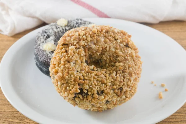 Food and Bakery, Plate of Delicious Chocolate Donuts Toppings with Icing and Peanuts.