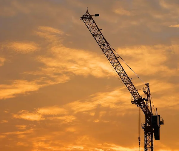 Industrial Construction Crane and Building Silhouettes at Sunrise