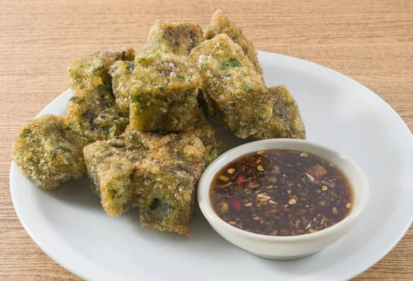 Fried Chinese Pancake or Fried Steamed Dumpling Made of Garlic Chives, Rice Flour and Tapioca Flour Served with Spicy Soy Sauce. Traditional Food of China.