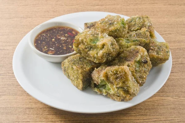 Plate of Fried Chinese Pancake or Fried Steamed Dumpling Made of Garlic Chives, Rice Flour and Tapioca Flour Served with Spicy Soy Sauce. Traditional Food of China.