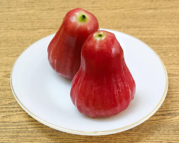 Dwie czerwone jabłka na białej płytce — Zdjęcie stockowe
