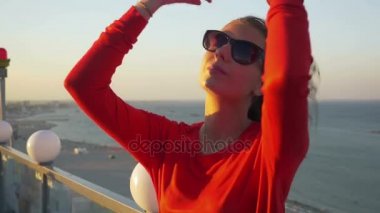 Güzel genç kadın bir Plajı manzaralı bir çatı üzerinde dans