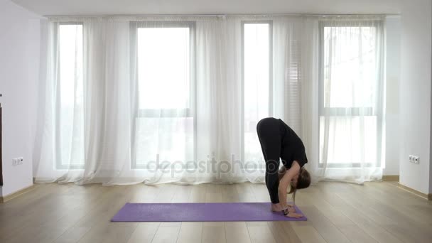 Joven mujer rubia delgada practicando y enseñando ejercicios de yoga en estudio — Vídeos de Stock