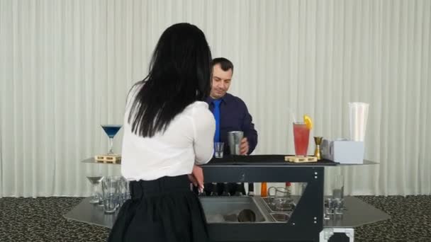 Bartender mixing cocktail shots drinks for woman waiting at private event — Stock Video