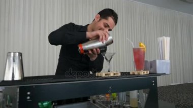 Barmen dökme karışık içki kokteyl shaker yavaş çekimde bir bardak içine