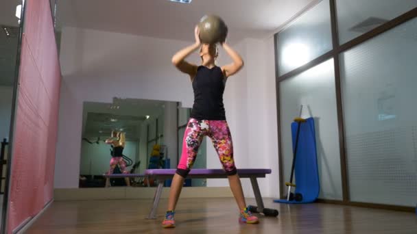 Mujer hacer ejercicio con la pelota de fitness gimnasio interior — Vídeos de Stock