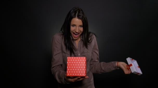 Excited and surprised young woman opens her present gift box on her birthday — Stock Video