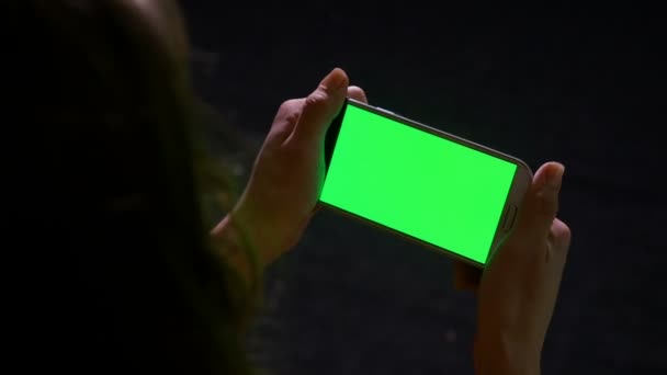 Mujer leyendo contenido en línea en el teléfono inteligente con pantalla verde — Vídeo de stock