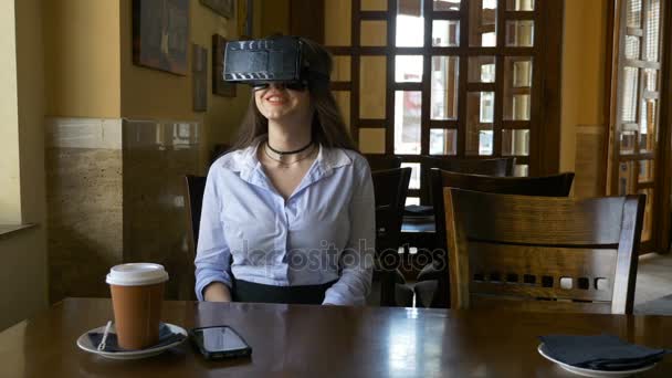 Mulher bonita no café testando wearable VR realidade virtual fone de ouvido pela primeira vez — Vídeo de Stock