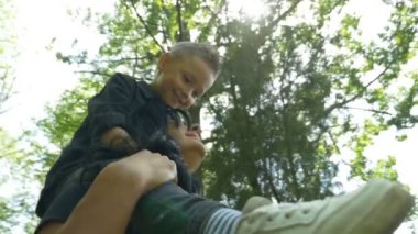 İki ormanda etrafında dönüyor iken annesi omuz üzerinde duran çocuk