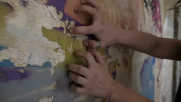 Closeup of woman hands and fingers scratching a ruined wall — Stock Video