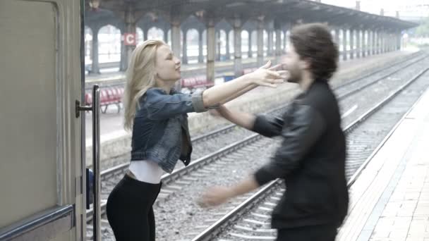 Feliz casal de adolescentes se reúne abraço e beijos na estação ferroviária — Vídeo de Stock