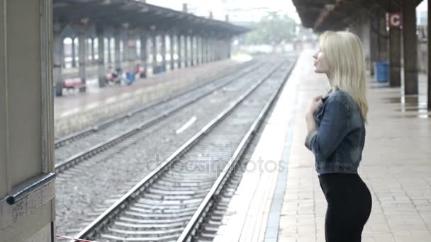 Mujer joven emocionada esperando a su novio llegada en la estación de la plataforma del tren ferroviario — Vídeo de stock