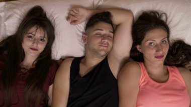 En sevdiği hangisi karar vermeye çalışırken yatakta iki kız arkadaşım ile yakışıklı genç
