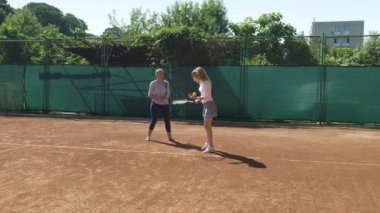 Kızı sahada koçu ile tenis dersleri alıyor