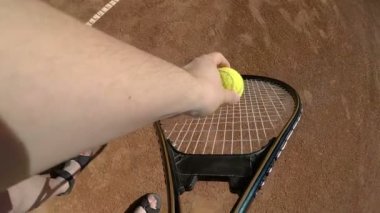 POV bakış açısı yavaş raket tutarak ve Tenis Kortu bir yaz günü hizmet tenisçi el ile