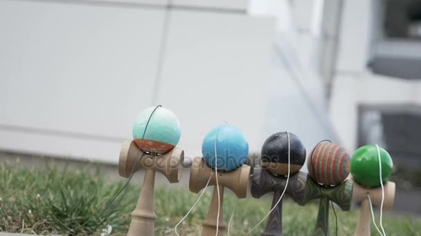 Slow motion of kendama toys being blown away by the wind — Stock Video