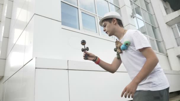 Cool kid Bilboquet bal vangen op spike vordert om een ingewikkelde truc en niet in slow motion — Stockvideo