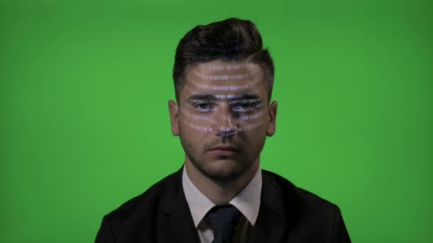 Young businessman entrepreneur working in IT industry having a hologram programming code on face on a green screen background — Stock Video