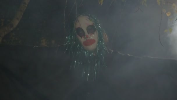 Halloween skräck clown sitter i mörkret utanför i rök utför en dansande död rituella och onda skratta — Stockvideo