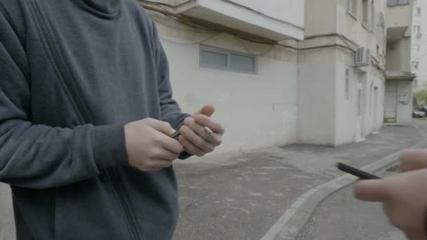 Cliente que compra drogas de cocaína na esquina da rua de um traficante de drogas que aceita pagamento de criptomoeda bitcoin a partir de smartphone — Vídeo de Stock