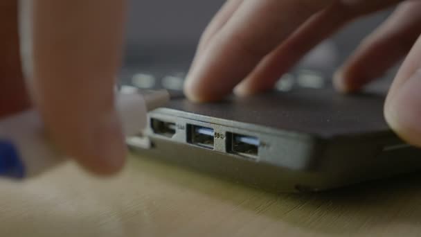 Mannelijke student inpluggen in een geheugengegevens stok in leraren usb laptop poort te downloaden zijn project en hen veilig verwijderen — Stockvideo