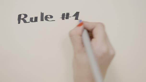 Girl hands writing inspirational quote rule hashtag one of life do what makes you happy and drawing a smiley face using red and black pen — Stock Video