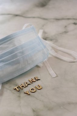 Fotokopi alanı olan mermer zemini imzalayan cerrahi maske. Dikey 