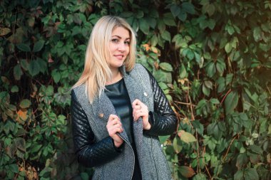 Ivy bir arka plan üzerinde çekici genç kadın bırakır