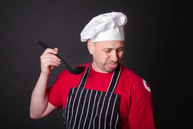 Elinde bir kepçe ile memnun aşçı portresi