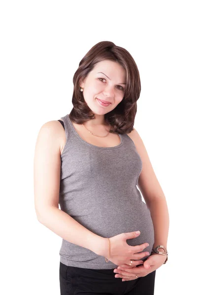 Cute młoda kobieta w ciąży w studio, na białym tle portret. — Zdjęcie stockowe