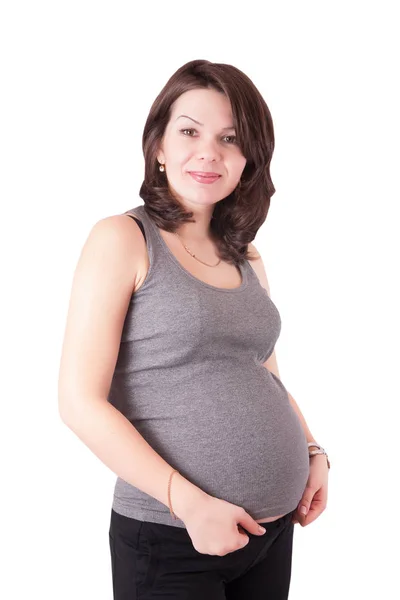 Potret seorang wanita hamil muda yang lucu di studio, terisolasi . — Stok Foto