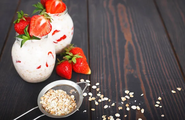 Healthy breakfast: overnight oats with fresh strawberries in a jar.