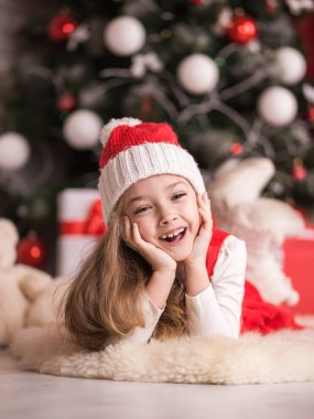 Bir Noel ağacı arka plan üzerinde sevimli küçük bir kız portresi.