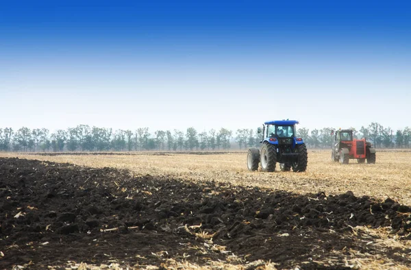 Modern tractors in the field during planting. The concept of agricultural industry.