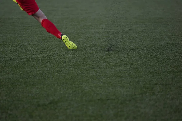 Fotbollsspelare skytte fotboll bollen på konstgräs fält — Stockfoto