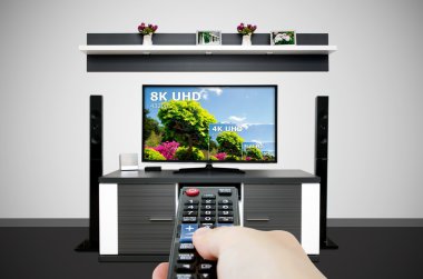 Watching television in modern TV room. Compare of television resolution clipart