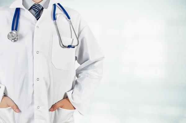 Doctor with hands in pocket on blurred background. — Stock Photo, Image