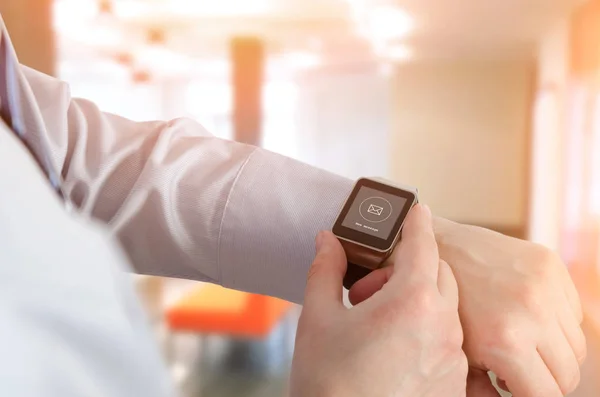 Man using smartwatch with e-mail notifier — Stock Photo, Image