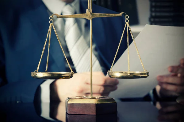 Weight scale of justice, lawyer in background — Stock Photo, Image