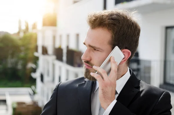 Handsome businessman talking on phone city outdoor — Stock Photo, Image