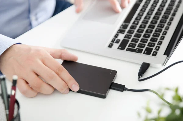 External backup disk hard drive connected to laptop — Stock Photo, Image