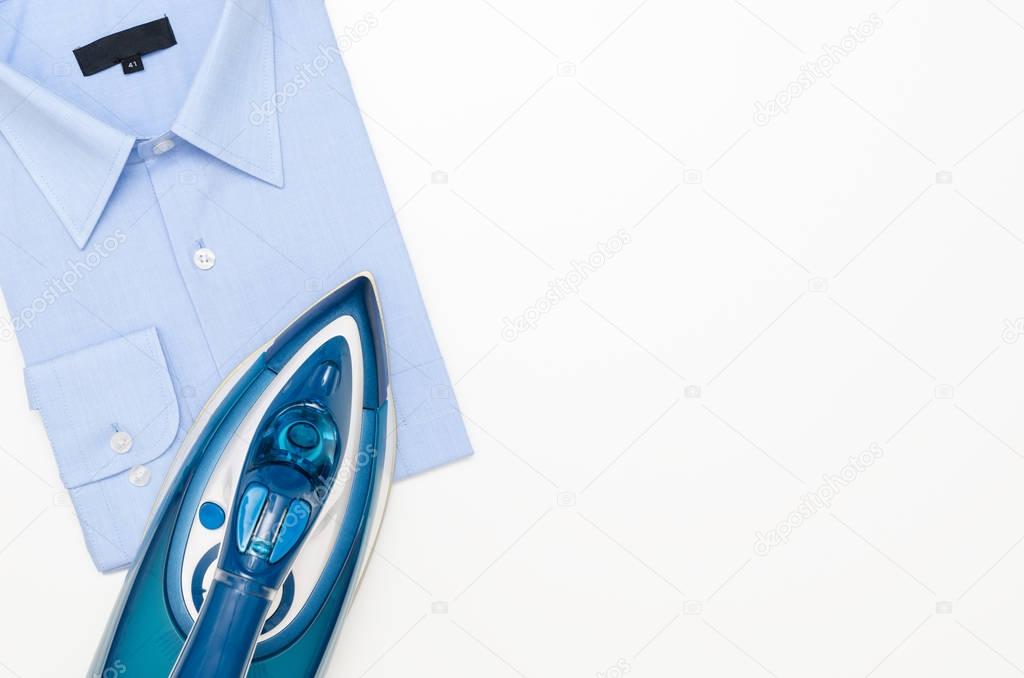 Blue iron and shirt on ironing board