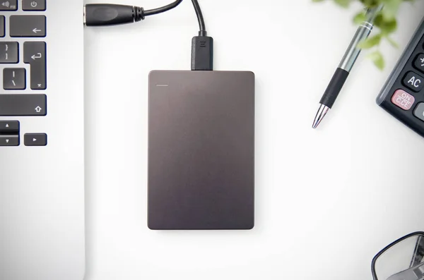 External backup disk hard drive connected to laptop — Stock Photo, Image