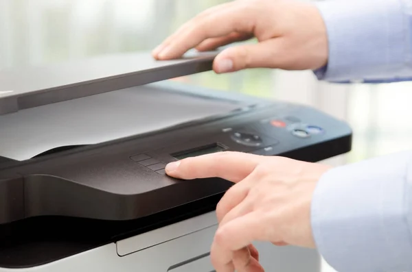 Hand press button on panel of printer — Stock Photo, Image