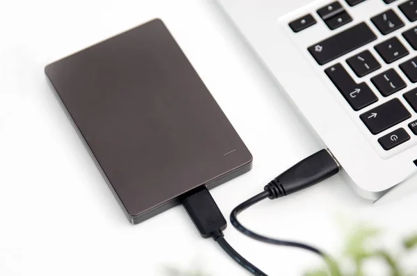 External backup disk hard drive connected to laptop — Stock Photo, Image